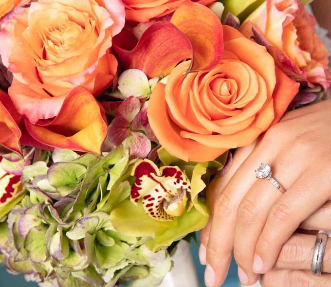 Flowers with a woman's hand with a wedding ring
